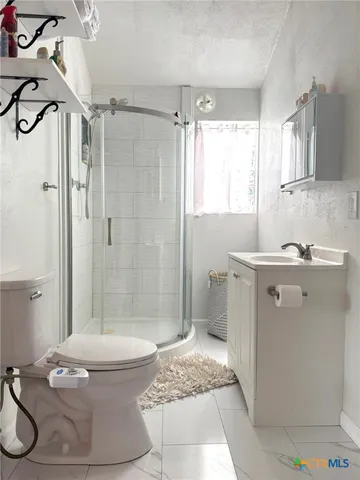 a bathroom with a sink toilet and shower