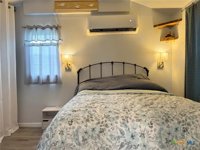 a large bed sitting in a kitchen next to a window