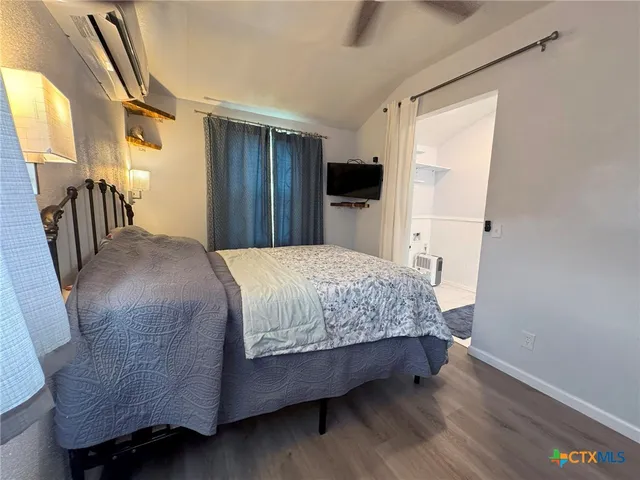 a bedroom with a bed closet and a window