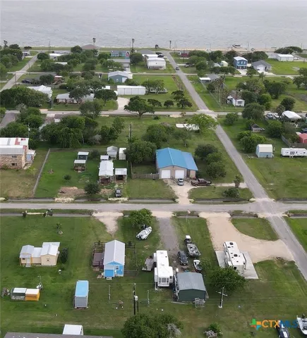an aerial view of a house with swimming pool and outdoor seating