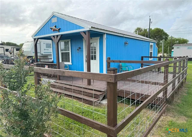 a view of a house with wooden deck