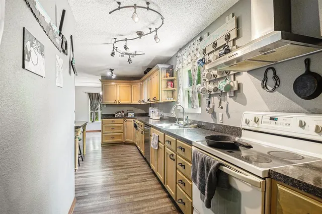 a kitchen with a stove a sink and a refrigerator