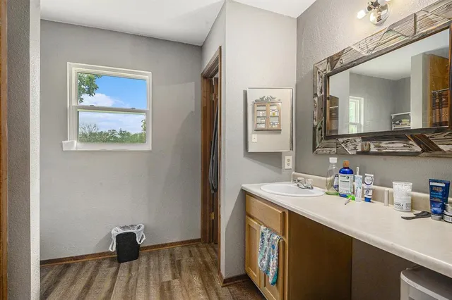 a bathroom with a sink mirror and vanity