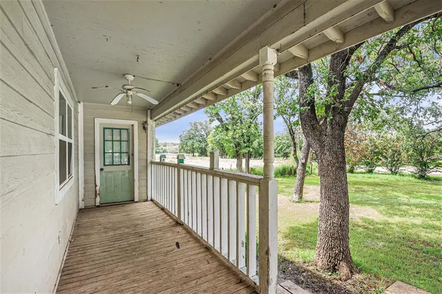 a view of a porch with wooden floor and outdoor space