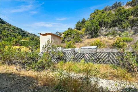 a view of a back yard of the house and a yard