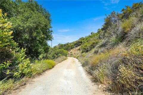 a view of a dry yard with mountains in the background