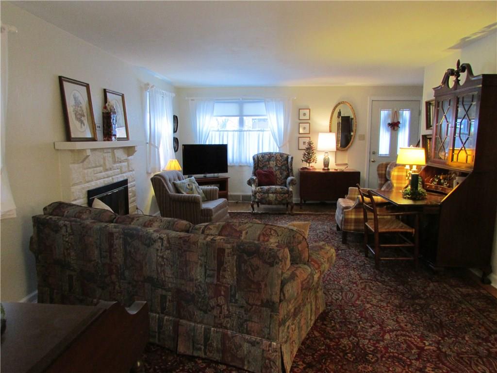 1136 Varner Road Whitehall, PA 15227 - Photo 3 of 25 Spacious living room 22.5' x 13.25, so much light floods in, neutral plaster walls, lovely hardwood floors, log burning fireplace and coat closet.