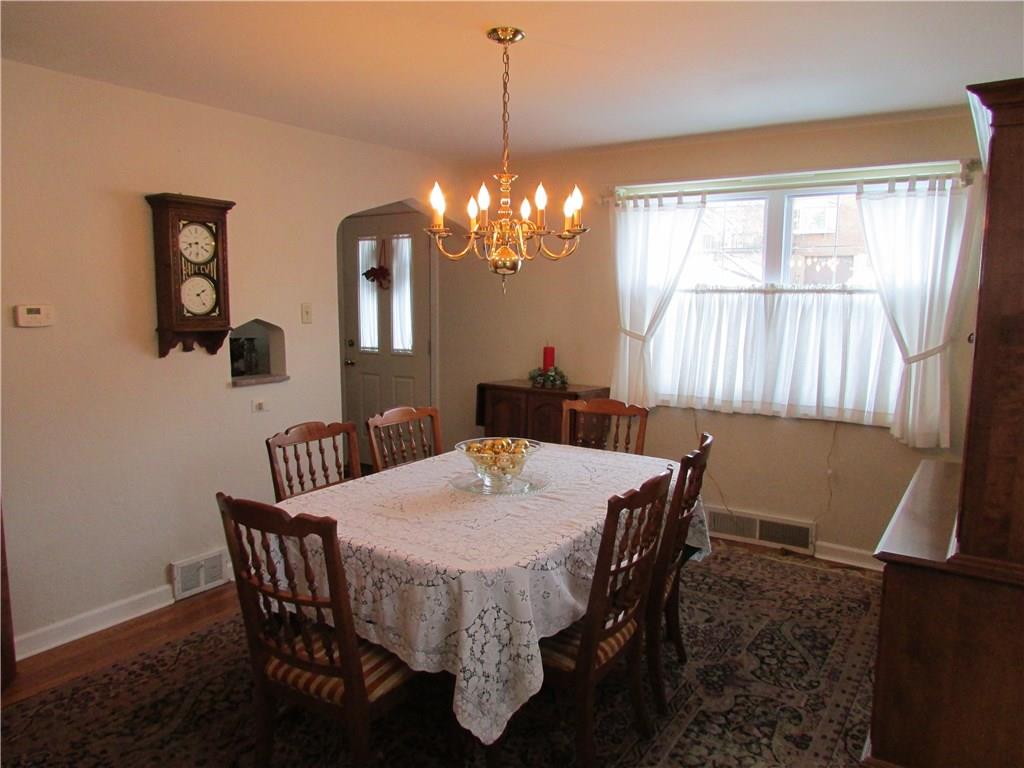 1136 Varner Road Whitehall, PA 15227 - Photo 4 of 25 Large formal dining room with more hardwood floors, large windows, classic colonial chandelier and cute wall nook.