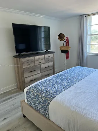 a view of a livingroom with wooden floor and cabinets