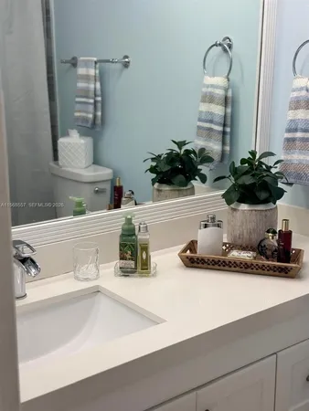 a white toilet sitting next to a shower curtain