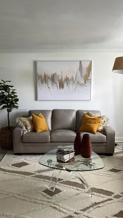 a living room with furniture and a potted plant