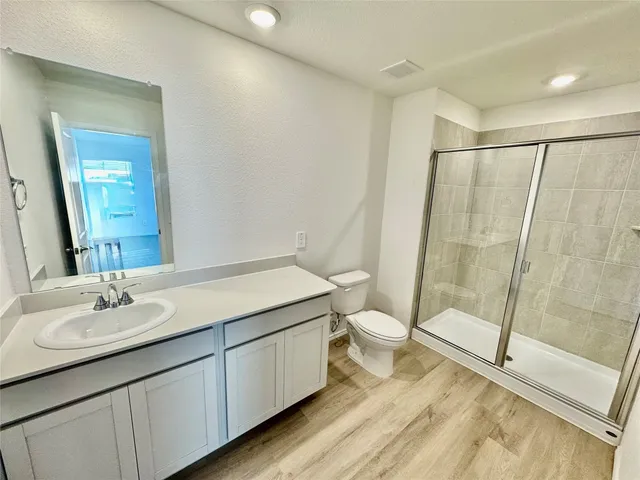 a bathroom with a sink and mirror with toilet