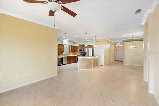 a view of a kitchen with a sink and a refrigerator