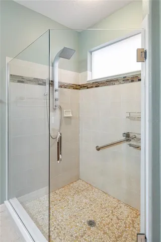 a bathroom with a glass shower door