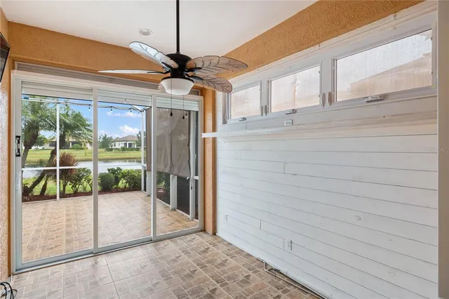 a view of a porch with wooden floor and a ceiling fan