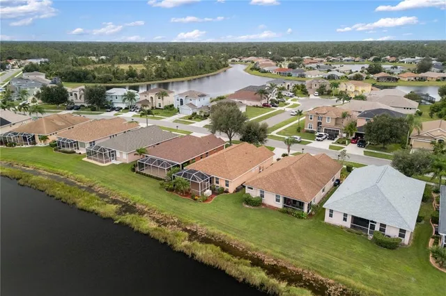 an aerial view of residential houses with outdoor space and river