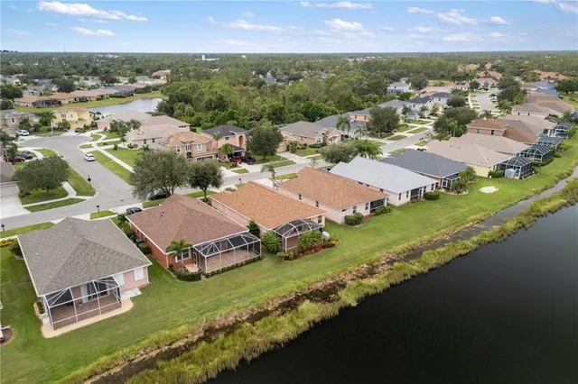 an aerial view of residential houses with outdoor space and river