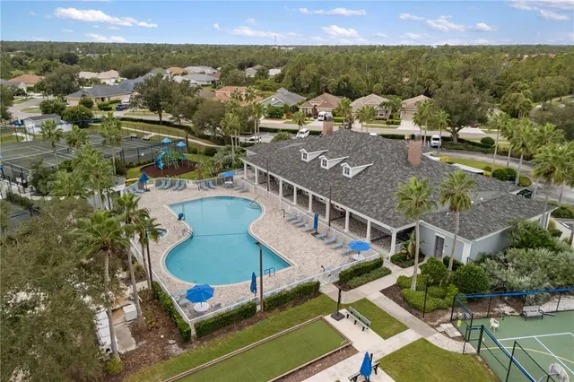an aerial view of residential houses with outdoor space and parking
