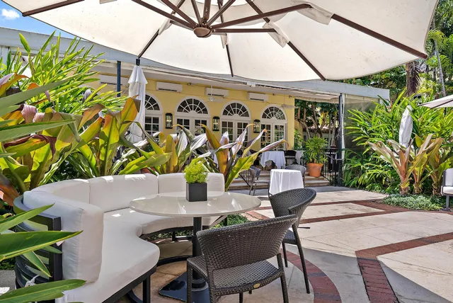 a view of a patio with table and chairs and potted plants
