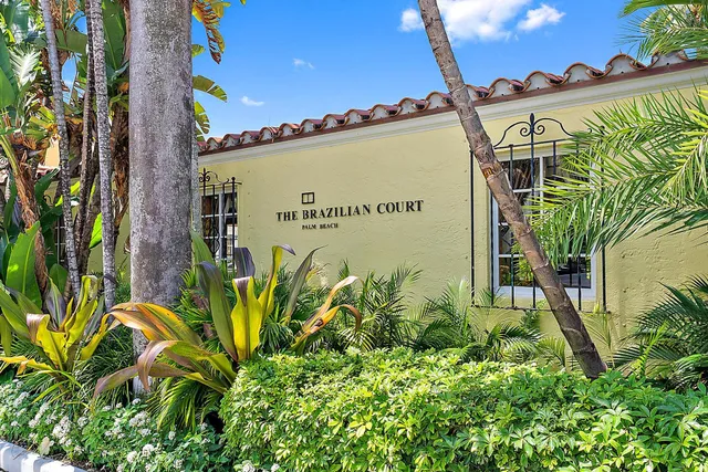 a sign on the wall next to a road