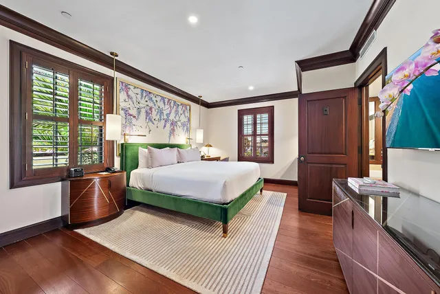 a bed room with a bed and a large window