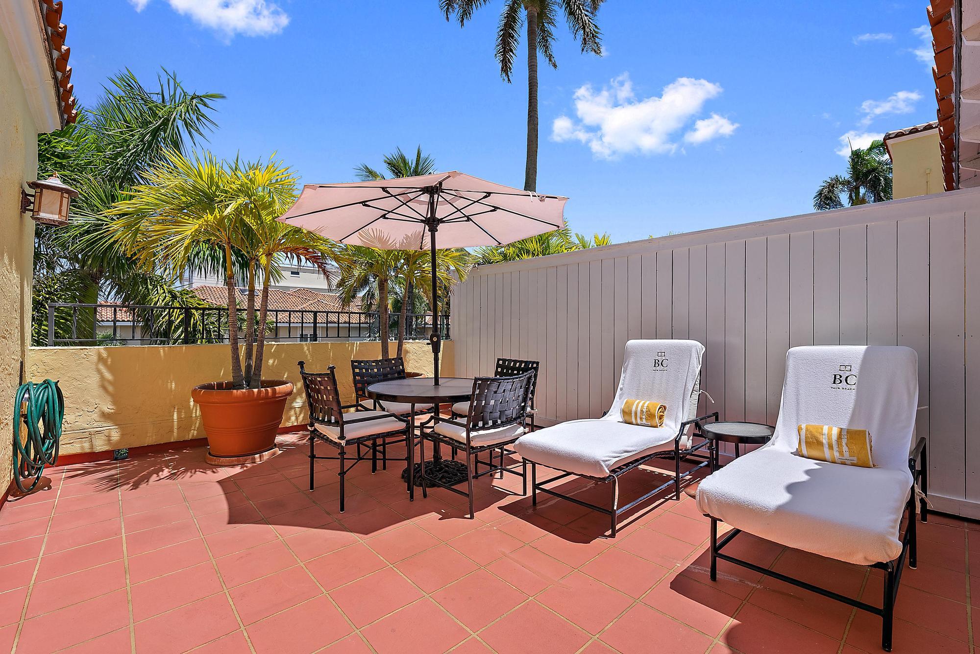 301 Australian Avenue, Unit 305 Palm Beach, FL 33480 - Photo 6 of 19 a view of a patio with a dining table and chairs
