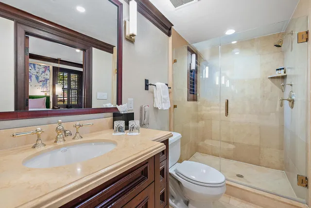 a bathroom with a sink toilet and shower