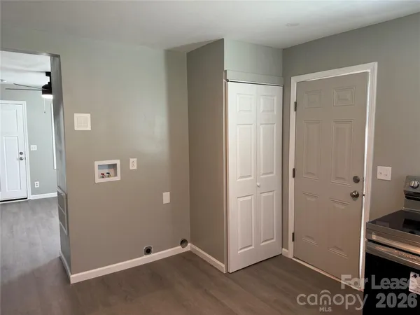 an empty room with wooden floor and closet