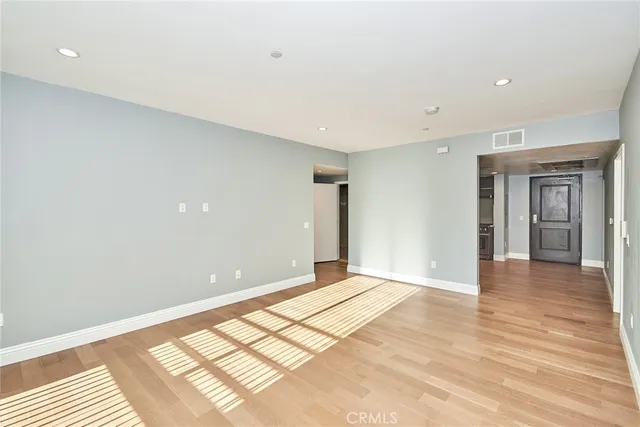 a view of a room with wooden floor and a window