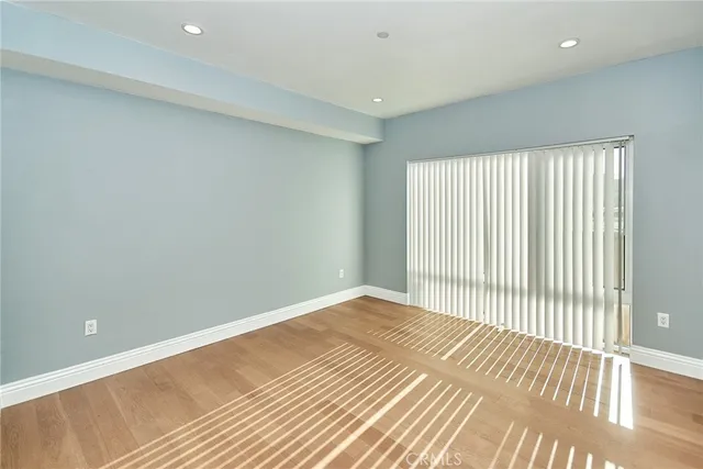 a view of a room with wooden floor and a bathroom
