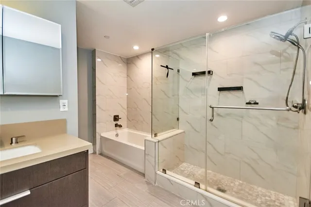 a bathroom with a shower and a sink