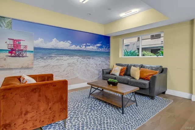 a living room with furniture a pool table and a fireplace