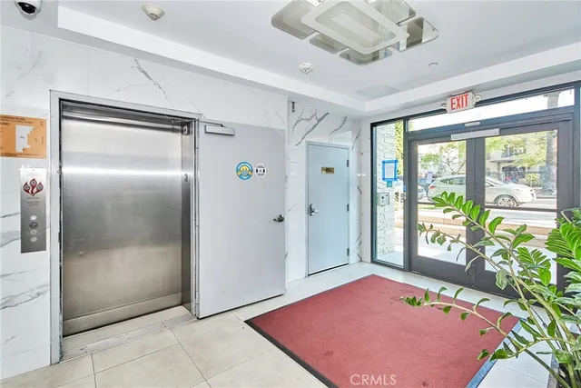 a view of a hallway with a table and chairs