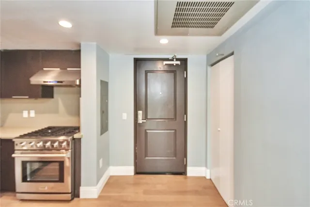 a large kitchen with stainless steel appliances granite countertop a refrigerator and a stove top oven