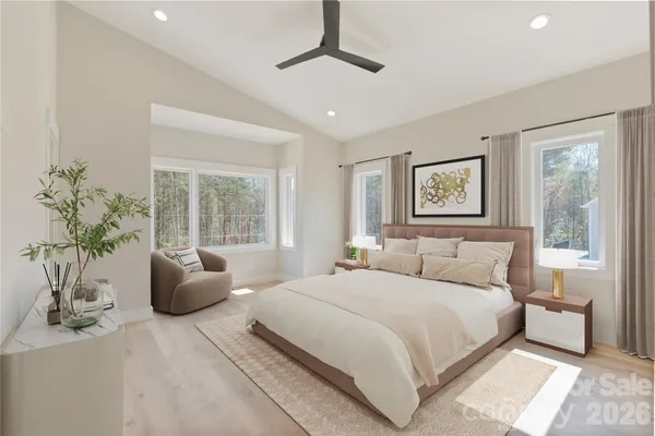a bedroom with a large bed and a chandelier