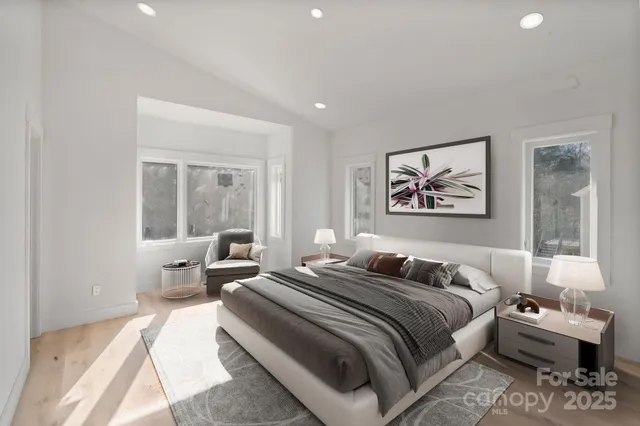 a bedroom with a large bed and a couch