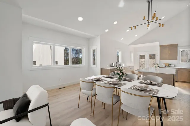 a view of a dining room with furniture and a chandelier