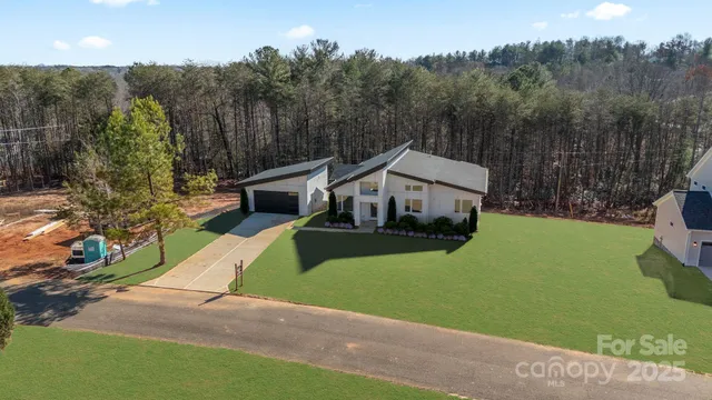 a front view of a house with a garden and yard