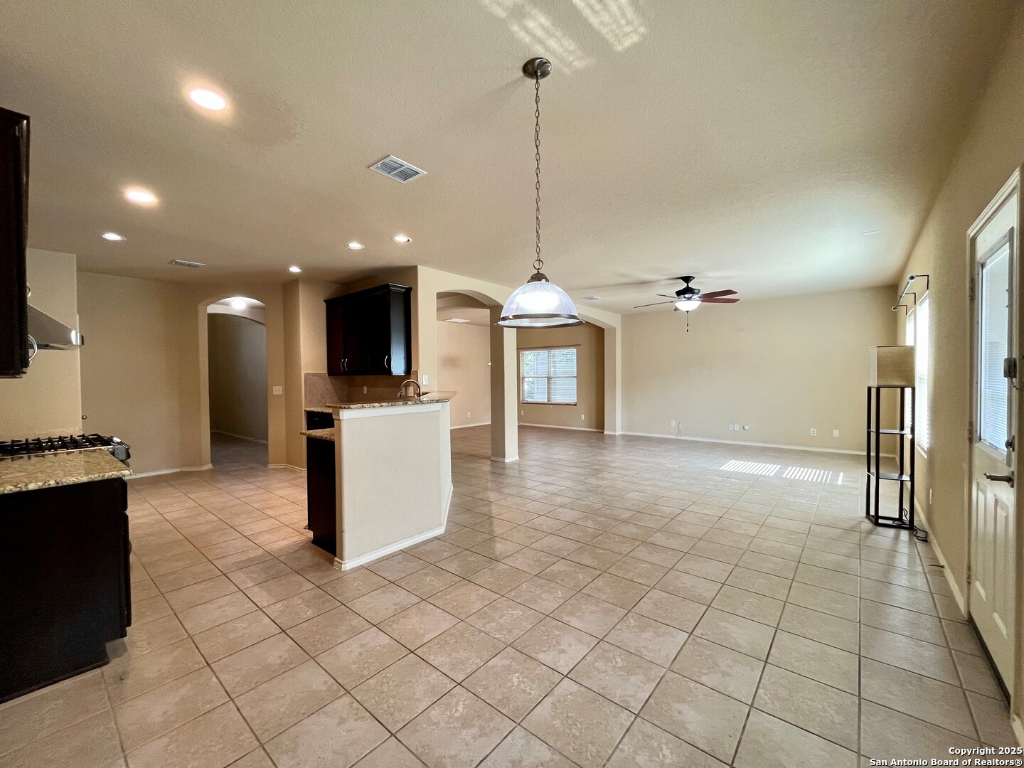 426 Tequila Ranch San Antonio, TX 78245 - Photo 11 of 24 a view of a kitchen with kitchen island granite countertop a refrigerator and a stove top oven