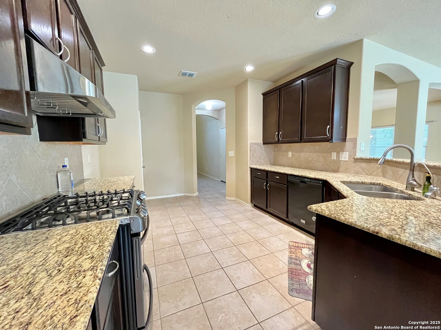 426 Tequila Ranch San Antonio, TX 78245 - Photo 12 of 24 a kitchen with a sink stove and cabinets