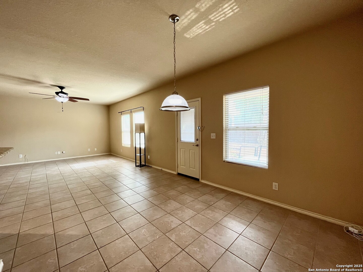 426 Tequila Ranch San Antonio, TX 78245 - Photo 13 of 24 a view of a livingroom with a chandelier fan and windows