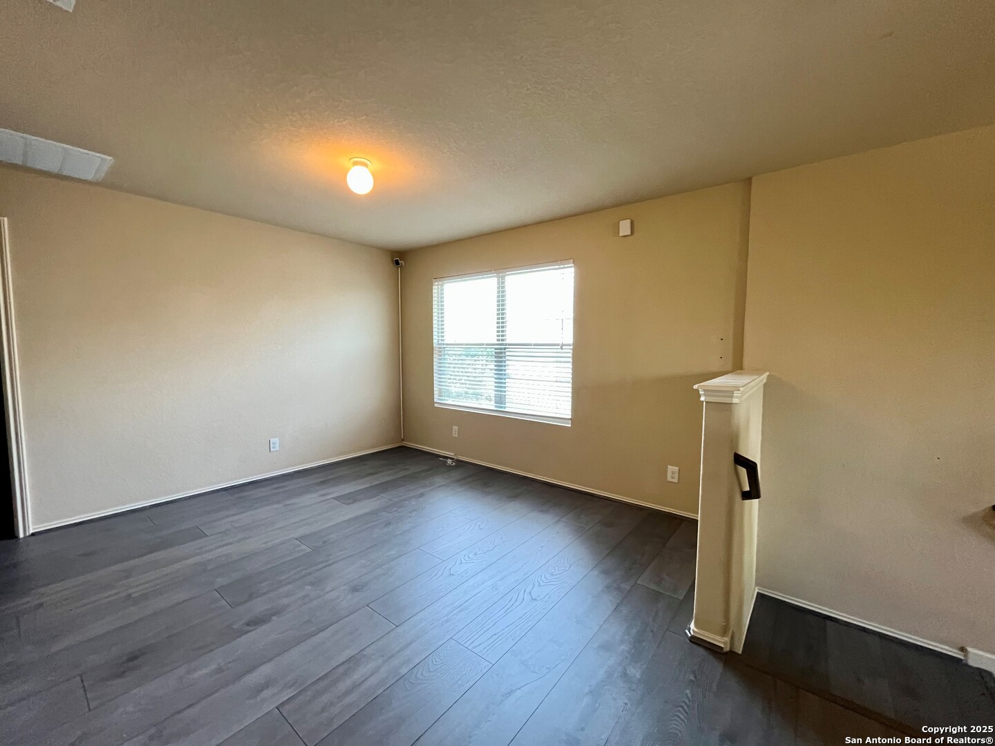 426 Tequila Ranch San Antonio, TX 78245 - Photo 14 of 24 a view of an empty room with wooden floor and a window
