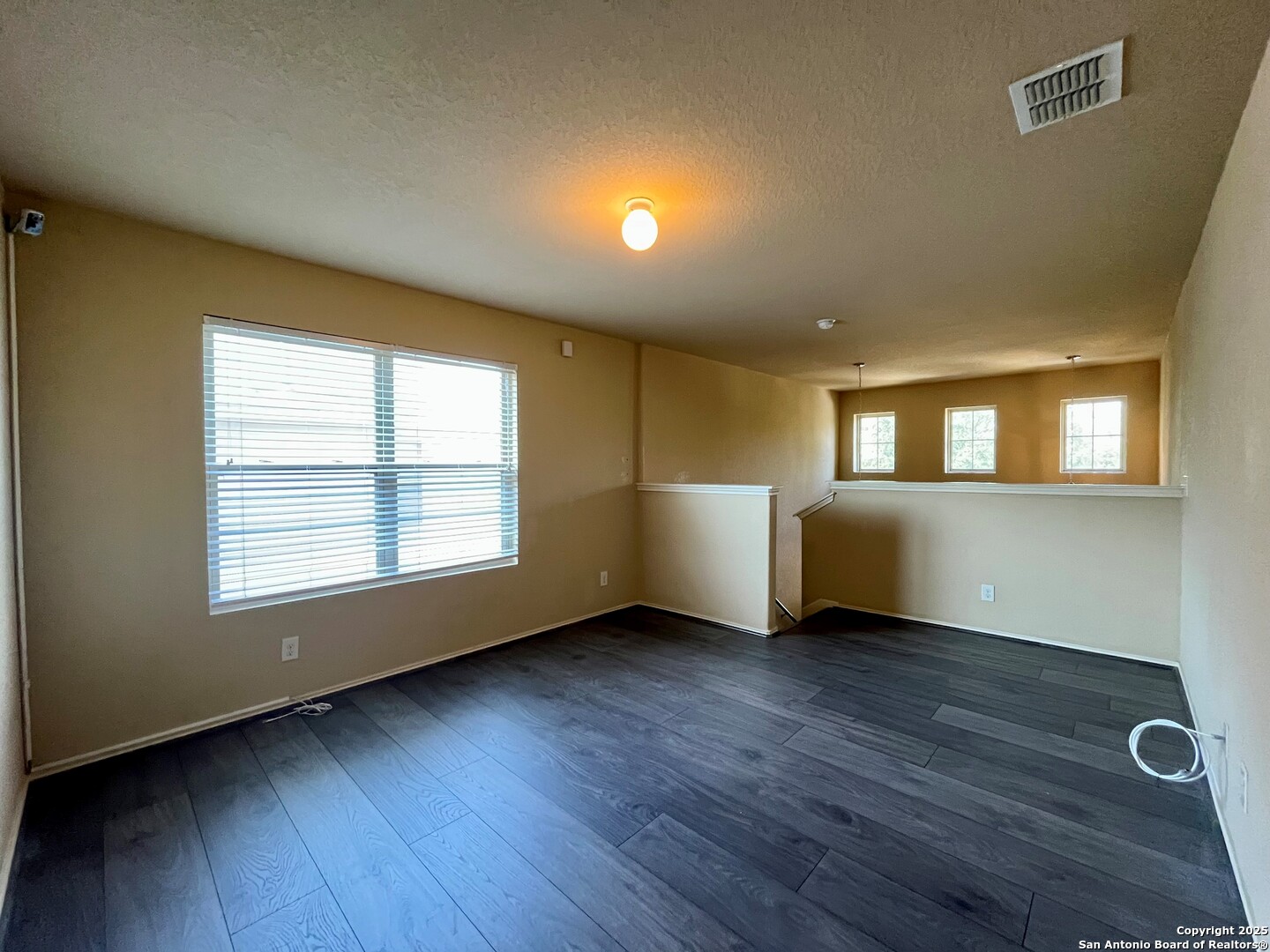 426 Tequila Ranch San Antonio, TX 78245 - Photo 15 of 24 a view of an empty room with wooden floor and a window