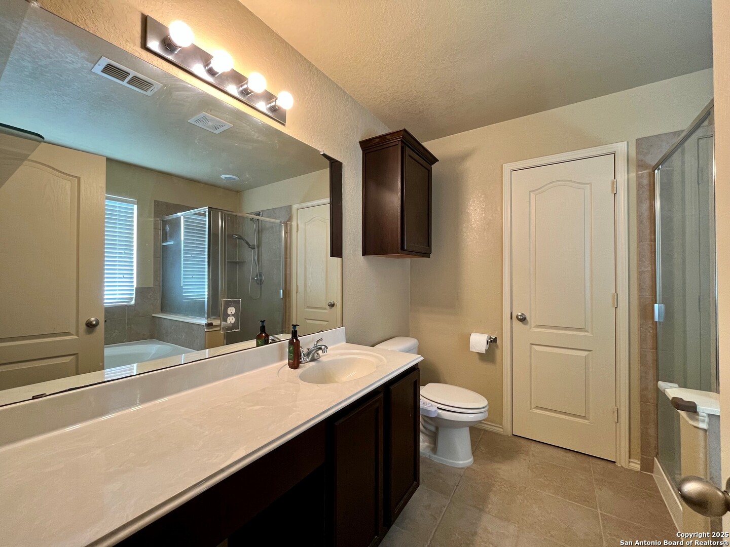 426 Tequila Ranch San Antonio, TX 78245 - Photo 18 of 24 a bathroom with a sink a toilet and shower
