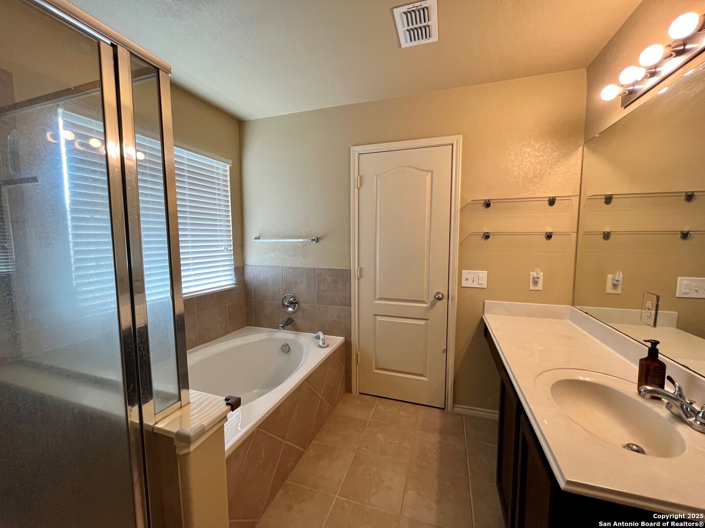 426 Tequila Ranch San Antonio, TX 78245 - Photo 18 of 25 a bathroom with a tub sink and mirror