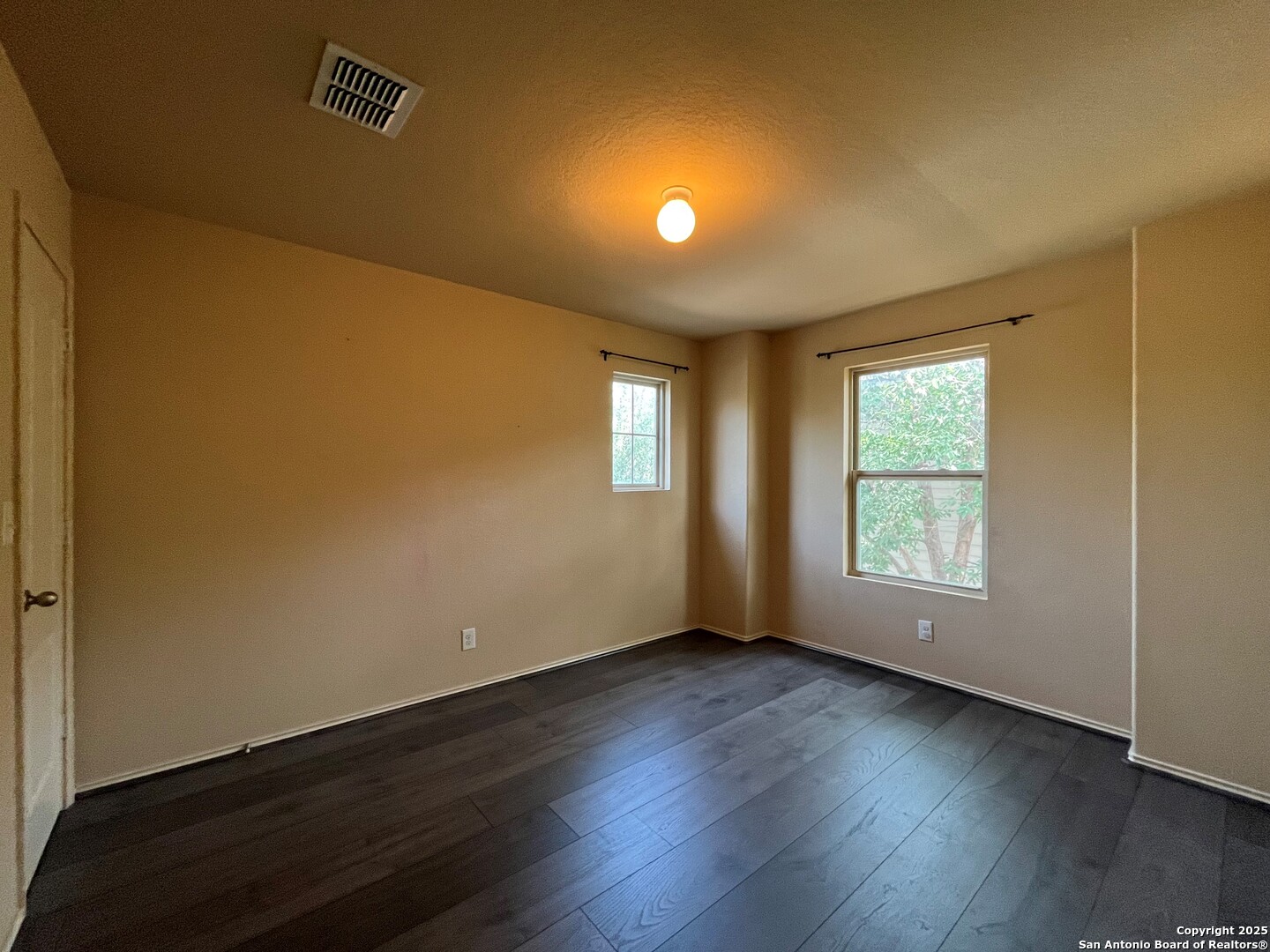 426 Tequila Ranch San Antonio, TX 78245 - Photo 21 of 25 a view of an empty room with wooden floor and a window