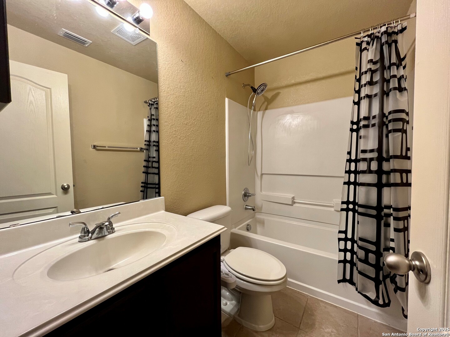 426 Tequila Ranch San Antonio, TX 78245 - Photo 22 of 25 a bathroom with a sink toilet a shower and a mirror
