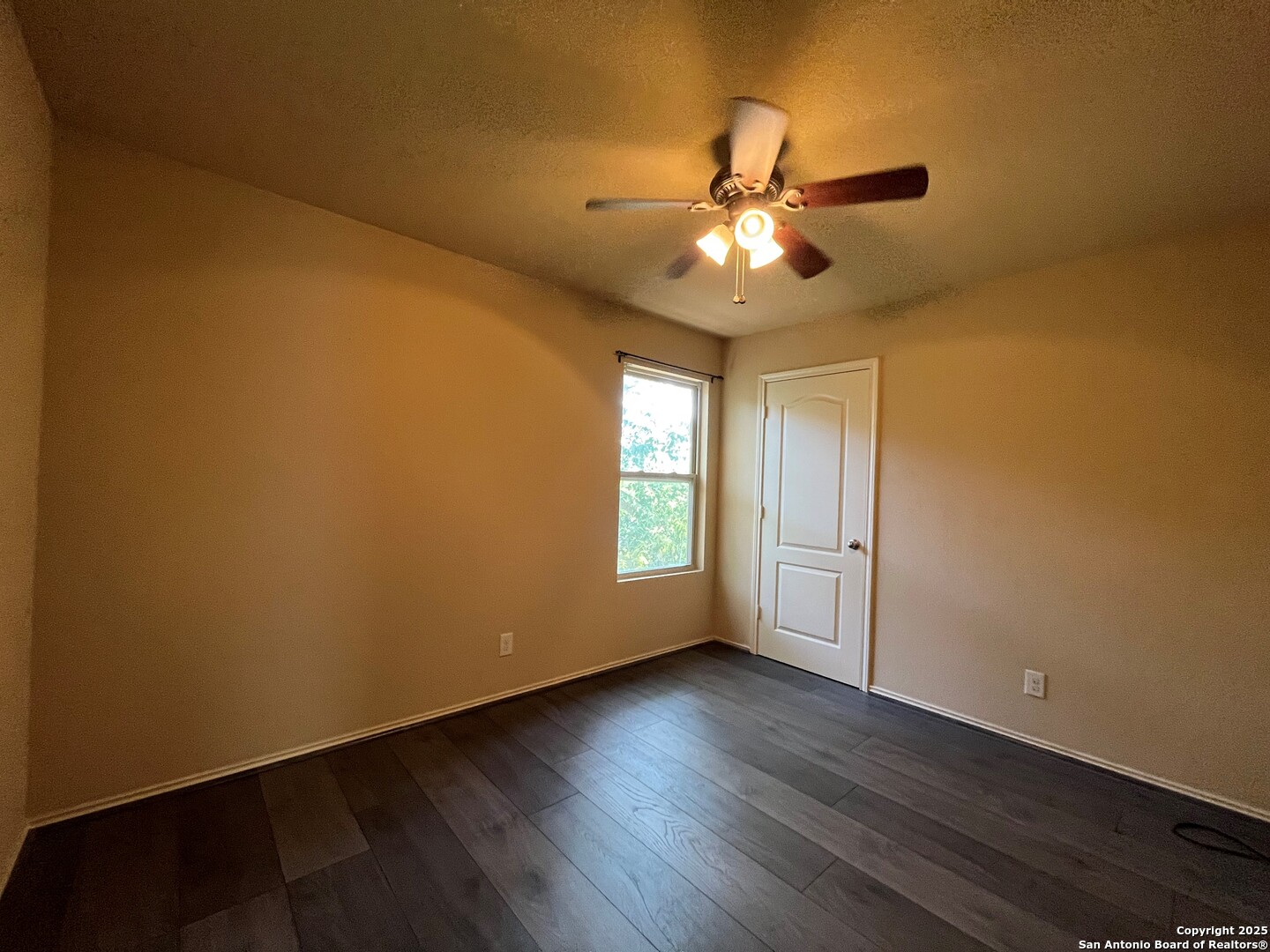 426 Tequila Ranch San Antonio, TX 78245 - Photo 22 of 24 a view of an empty room with wooden floor and a window