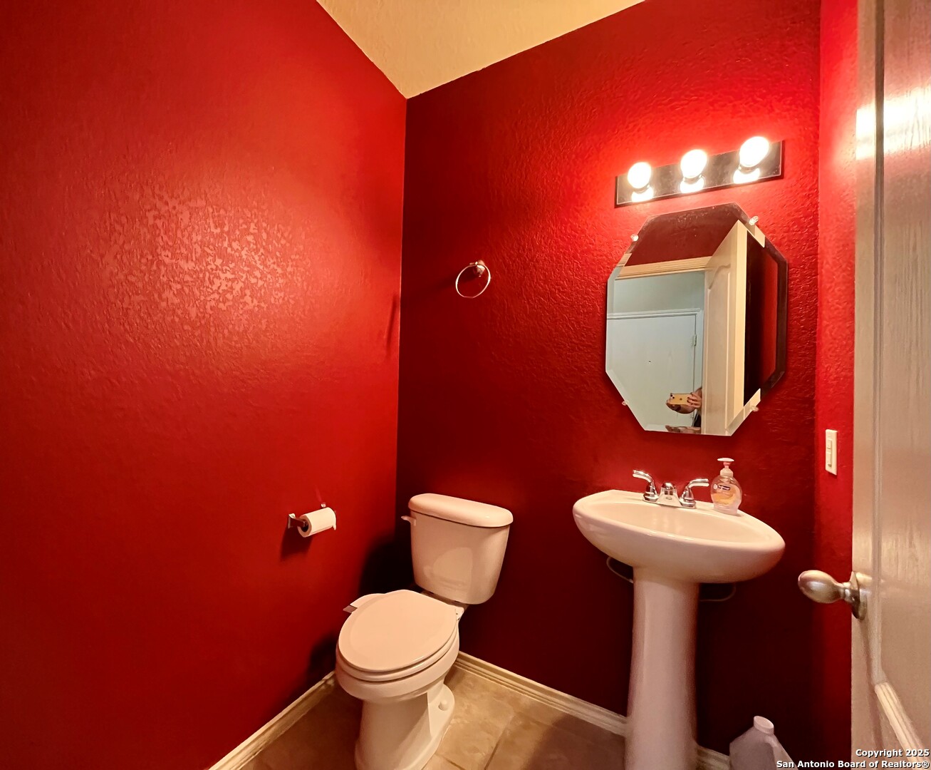 426 Tequila Ranch San Antonio, TX 78245 - Photo 6 of 24 a bathroom with a toilet sink and mirror