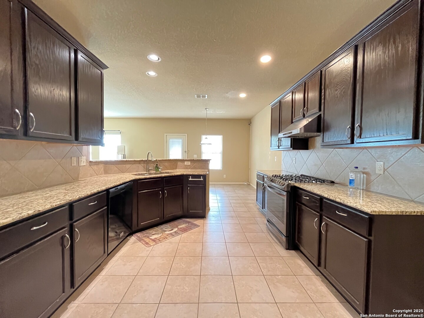 426 Tequila Ranch San Antonio, TX 78245 - Photo 7 of 24 a large kitchen with stainless steel appliances granite countertop a sink and cabinets